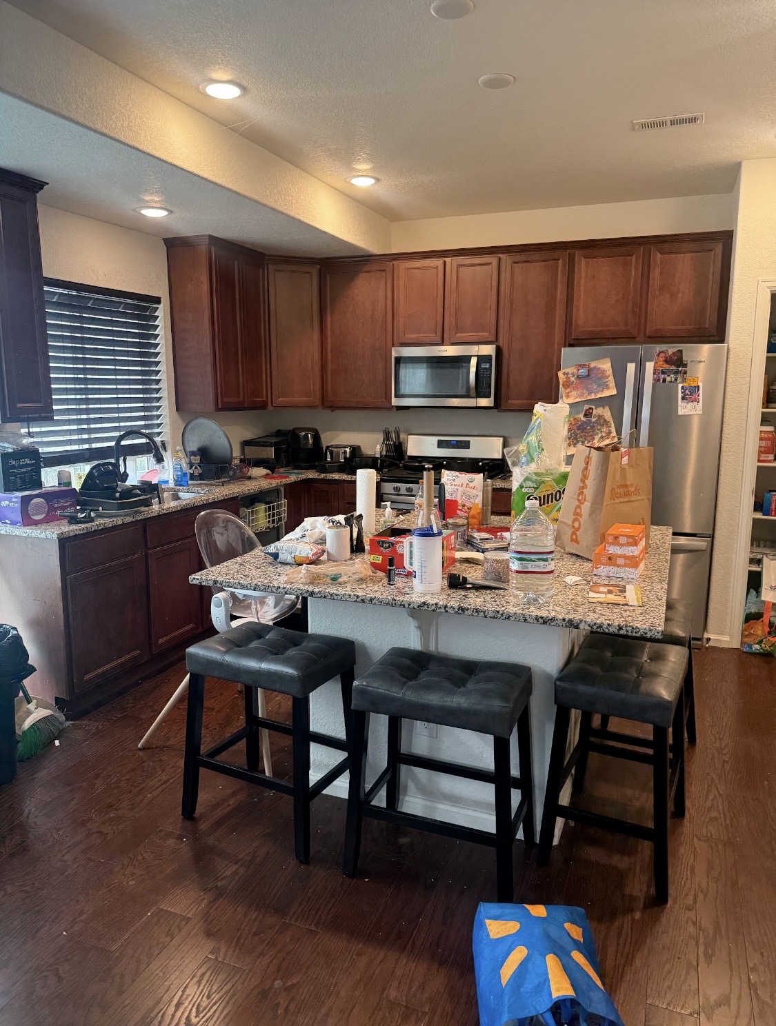 Before: kitchen island and countertops covered with items