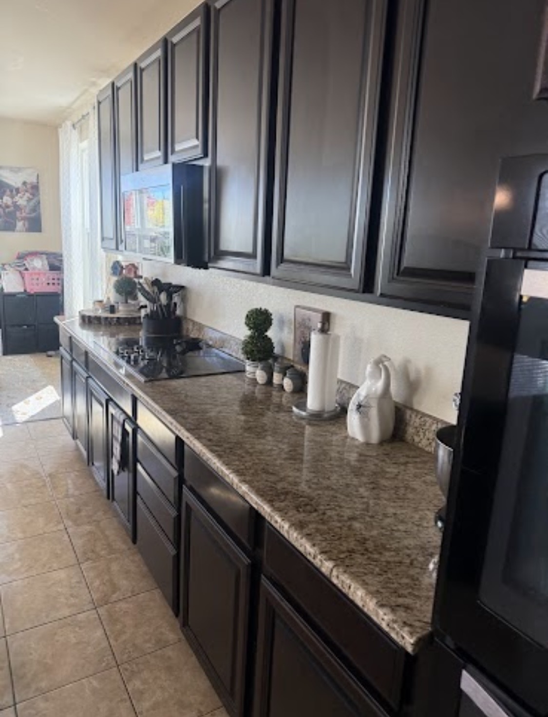 The cleaned kitchen counter and dark cabinets