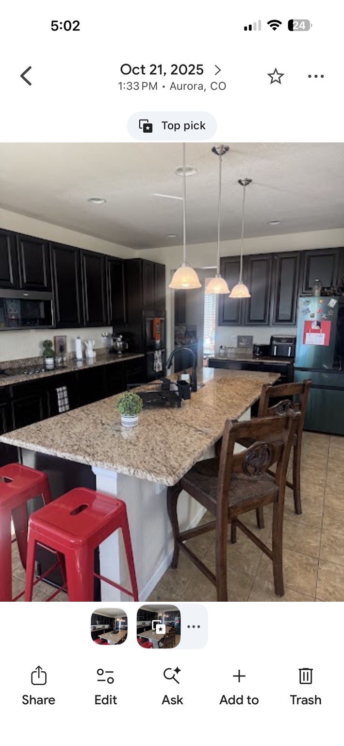 After: clean kitchen island and tile beside the red stools